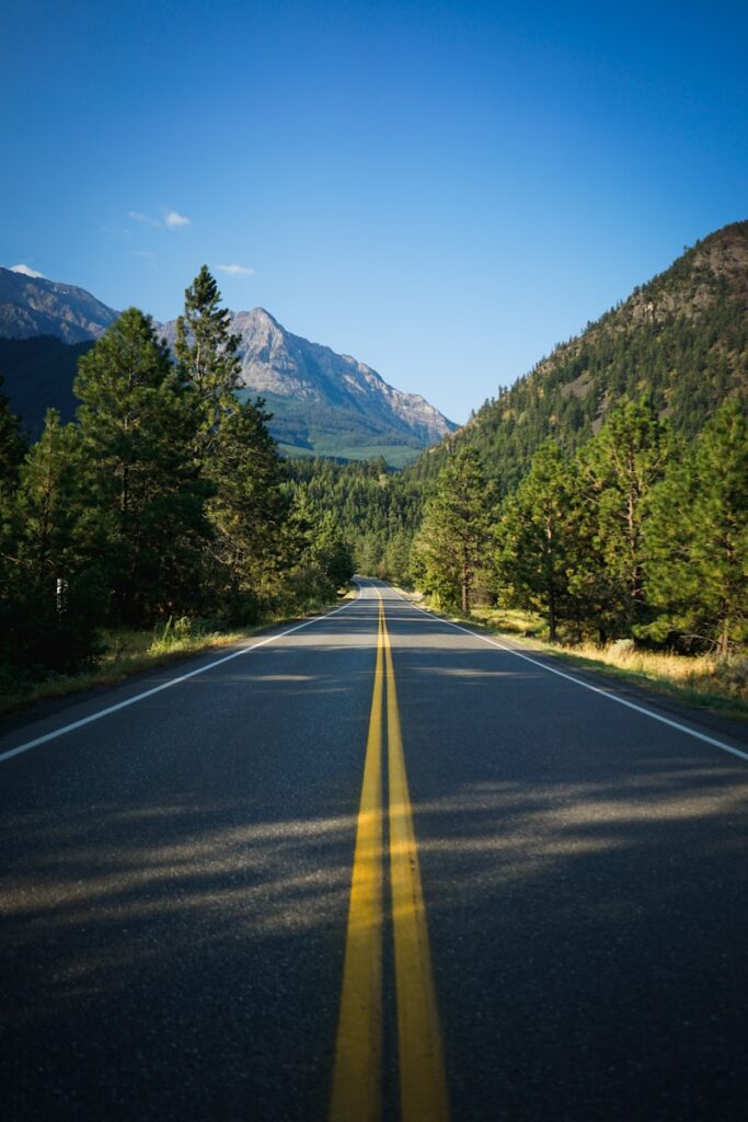 An empty road with a mountain in the background