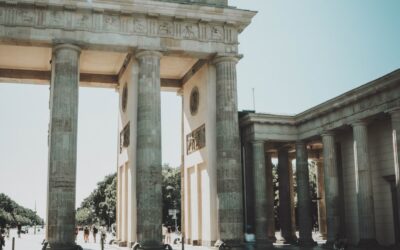 a large stone arch with statues on top of it