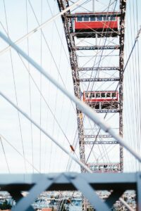 a red and white train traveling over a bridge