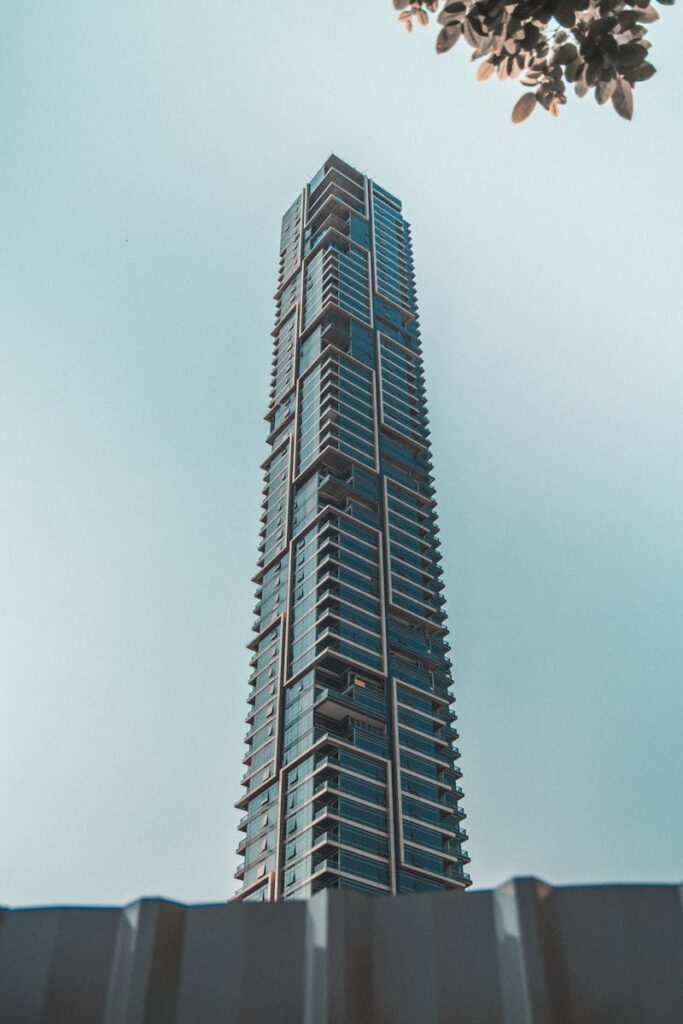 A towering modern skyscraper in Bangkok showcasing futuristic architecture against a clear sky.