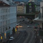 a city street filled with traffic next to tall buildings