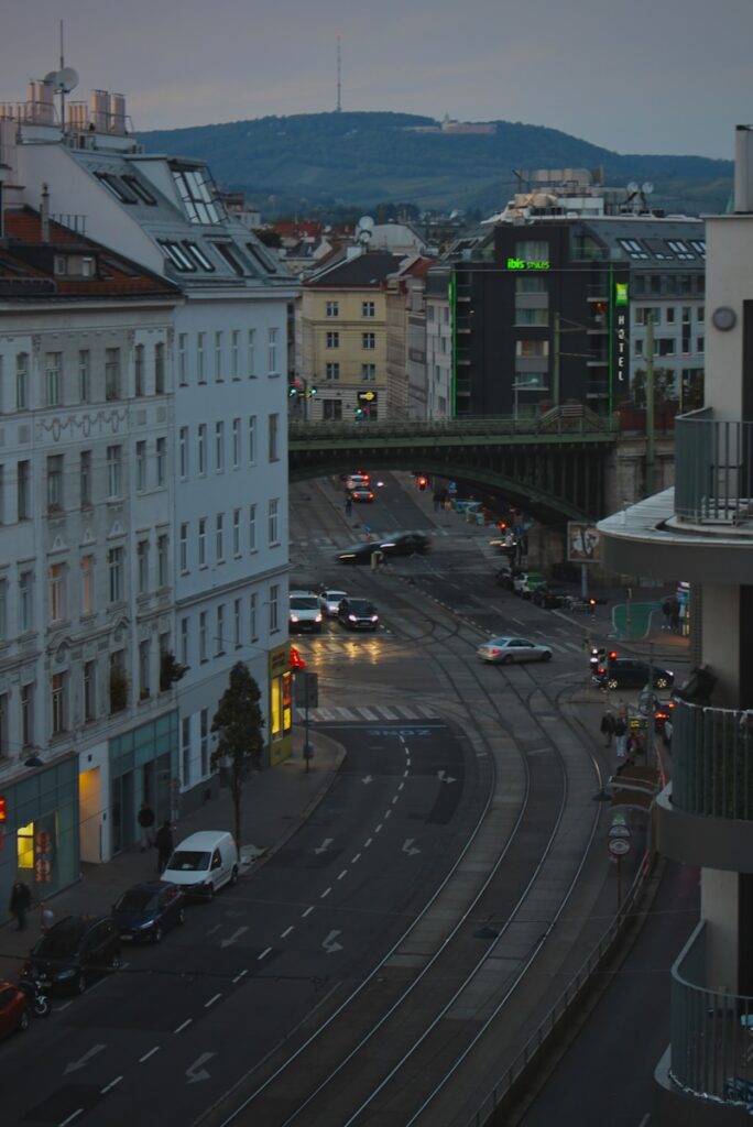 a city street filled with traffic next to tall buildings