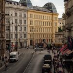 View of busy street in Vienna, Austria with historic buildings and urban life.